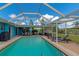 Large screened pool with plenty of patio furniture for lounging at 125 Severin Se Rd, Port Charlotte, FL 33952