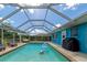 Refreshing screened pool with lounge chairs and floating toys at 125 Severin Se Rd, Port Charlotte, FL 33952