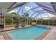 Inviting screened pool with lounge chairs and patio furniture at 125 Severin Se Rd, Port Charlotte, FL 33952