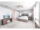 Bright bedroom featuring a king-size bed, a desk, and large windows at 14138 Poppy Field Loop # 4122, Punta Gorda, FL 33955