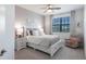 Guest bedroom with a queen bed and a comfortable sitting area at 14138 Poppy Field Loop # 4122, Punta Gorda, FL 33955