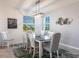 Modern dining room with a dark wood table and gray chairs at 14138 Poppy Field Loop # 4122, Punta Gorda, FL 33955