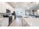 Open concept kitchen with island and stainless steel appliances at 14138 Poppy Field Loop # 4122, Punta Gorda, FL 33955