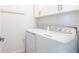 Bright laundry room with washer, dryer, and white cabinets at 14138 Poppy Field Loop # 4122, Punta Gorda, FL 33955