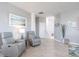 Relaxing living room with gray armchairs and tiled floors at 14138 Poppy Field Loop # 4122, Punta Gorda, FL 33955