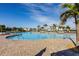 Expansive resort-style pool with numerous lounge chairs at 14138 Poppy Field Loop # 4122, Punta Gorda, FL 33955