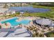 Community pool with lounge area, surrounded by lush landscaping at 14138 Poppy Field Loop # 4122, Punta Gorda, FL 33955