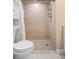 Bathroom with a shower stall, toilet and white vanity at 1415 San Cristobal Ave # A4, Punta Gorda, FL 33983