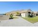 Front view of villa with driveway and landscaping at 1415 San Cristobal Ave # A4, Punta Gorda, FL 33983