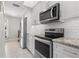 Modern kitchen with stainless steel appliances and white cabinetry at 1415 San Cristobal Ave # A4, Punta Gorda, FL 33983