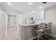 Kitchen with breakfast bar and view into living room at 1415 San Cristobal Ave # A4, Punta Gorda, FL 33983
