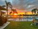 Sunset view of backyard pool and patio area at 1415 San Cristobal Ave # A4, Punta Gorda, FL 33983