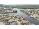 Aerial view of waterfront home community with lush landscaping and canals at 1435 Sea Fan Dr, Punta Gorda, FL 33950