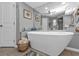 Bathroom with freestanding soaking tub and large mirror at 1435 Sea Fan Dr, Punta Gorda, FL 33950