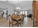 Open concept dining area with hardwood floors and views of the kitchen and living room at 1435 Sea Fan Dr, Punta Gorda, FL 33950