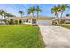 House exterior showcasing a single-Gathering home with a well-maintained lawn and driveway at 1435 Sea Fan Dr, Punta Gorda, FL 33950