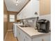 Clean laundry room with white cabinets, a sink, and space for storage at 1435 Sea Fan Dr, Punta Gorda, FL 33950