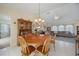 Bright dining room features a round wooden table with chairs, and views into the living room at 1717 Nuremberg Blvd, Punta Gorda, FL 33983