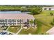 Aerial view of condo building, tennis courts, pool, and surrounding landscape at 175 Kings Hwy # 528, Punta Gorda, FL 33983
