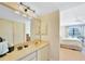 Bright bathroom with vanity, mirror, and access to bedroom at 175 Kings Hwy # 528, Punta Gorda, FL 33983