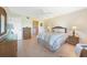 Main bedroom with wicker furniture and access to balcony at 175 Kings Hwy # 528, Punta Gorda, FL 33983