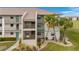 Two-story condo building with teal accents and lush landscaping at 175 Kings Hwy # 528, Punta Gorda, FL 33983