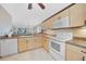 Kitchen with light wood cabinets, stainless steel appliances, and breakfast bar at 175 Kings Hwy # 528, Punta Gorda, FL 33983