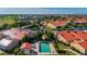 Aerial view of community pool and villas with orange tile roofs at 1780 Deborah Dr # 15, Punta Gorda, FL 33950
