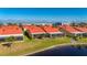 Aerial view of canal front homes with orange roofs and screened patios at 1780 Deborah Dr # 15, Punta Gorda, FL 33950