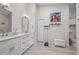 Double vanity bathroom with modern white cabinets and updated flooring at 1780 Deborah Dr # 15, Punta Gorda, FL 33950