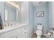 Small bathroom with light blue patterned walls and white vanity at 1780 Deborah Dr # 15, Punta Gorda, FL 33950