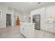 Open kitchen features white cabinets, an island, and stainless steel appliances at 1780 Deborah Dr # 15, Punta Gorda, FL 33950