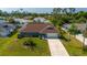 Single-story home with a large backyard and driveway at 18147 Cadillac Ave, Port Charlotte, FL 33948