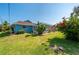 Landscaped backyard with lush greenery and a view of the house at 18147 Cadillac Ave, Port Charlotte, FL 33948