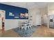 Casual dining area with white table and chairs, and a blue accent wall at 18147 Cadillac Ave, Port Charlotte, FL 33948