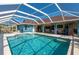 Large screened pool, spacious patio, and home access at 18147 Cadillac Ave, Port Charlotte, FL 33948