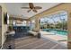Covered patio with pool view, bar seating, and lounge area at 18147 Cadillac Ave, Port Charlotte, FL 33948