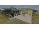 Spacious paver patio with screened enclosure, pool, and lush landscaping at 18204 Ackerman Ave, Port Charlotte, FL 33948