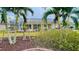 Home's back view showing pool and lush landscaping at 18204 Ackerman Ave, Port Charlotte, FL 33948