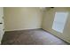 Simple bedroom with grey carpet and a window with blinds at 18204 Ackerman Ave, Port Charlotte, FL 33948