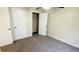 Small bedroom with grey carpet, double door closet and window with blinds at 18204 Ackerman Ave, Port Charlotte, FL 33948