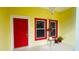 Front entrance with red door and potted plants at 18204 Ackerman Ave, Port Charlotte, FL 33948