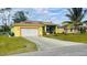 Single Gathering home with a two car garage and landscaped yard at 18204 Ackerman Ave, Port Charlotte, FL 33948