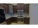 Modern kitchen with dark wood cabinets, granite countertops, and stainless steel appliances at 18204 Ackerman Ave, Port Charlotte, FL 33948