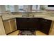 Modern kitchen island with double sink, granite countertops, and stainless steel dishwasher at 18204 Ackerman Ave, Port Charlotte, FL 33948