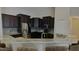 Modern kitchen with dark cabinets and granite counters at 18204 Ackerman Ave, Port Charlotte, FL 33948