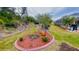 Landscaped yard with mature trees and curved border at 18204 Ackerman Ave, Port Charlotte, FL 33948