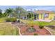 Landscaped backyard with mature trees and curved walkway at 18204 Ackerman Ave, Port Charlotte, FL 33948