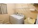 Laundry room with washer, dryer, utility sink, and overhead shelving at 18204 Ackerman Ave, Port Charlotte, FL 33948