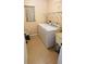 Laundry room with washer, dryer, utility sink, and overhead shelving at 18204 Ackerman Ave, Port Charlotte, FL 33948